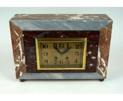 An Art Deco marble mantel clock, having stepped decoration