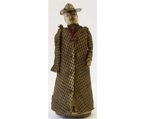 A German tinplate clockwork figure by Lehmann of a gentleman in long tweed overcoat with maroon felt lapels, painted features