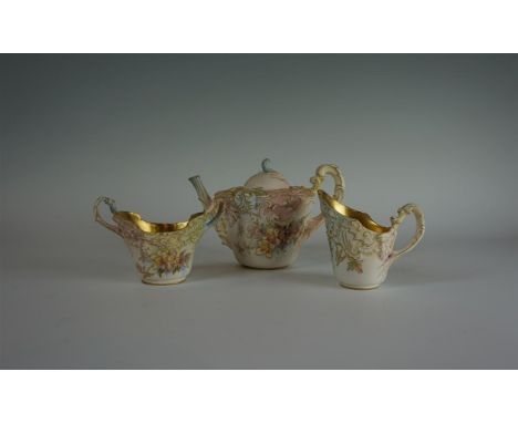A Doulton Burslem Art Nouveau three piece tea service, having relief and hand painted floral decoration, puce factory marks t