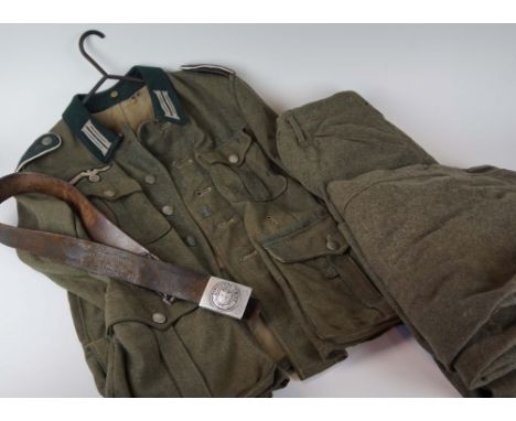 A World War II Nazi Germany Wehrmacht Corporals uniform, with olive green collar, cloth Eagle & Swastika badge, with part lab