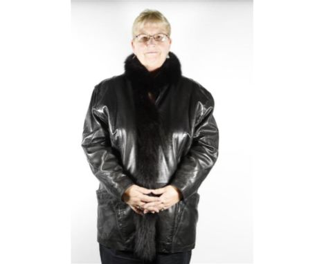 An early 1980's ladies soft black leather jacket, the loose fit jacket with popper front and black fox trim to front, with wi