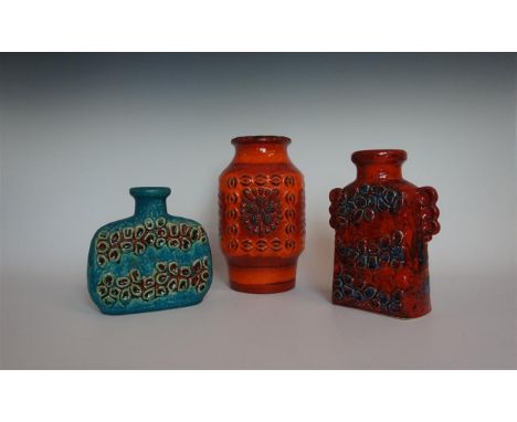 Three pieces of Dümler & Breiden West German Fat Lava ceramics to include a twin handled Domino vase, circa 1974, on a red an