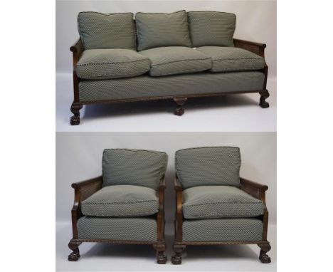 A good quality early 20th Century 'period-style' carved mahogany framed double walled bergere three piece lounge suite, compr