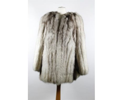 A late 1970's/early 1980's silver fox fur long length jacket, collarless with hook closures to front, slit pockets and fully 