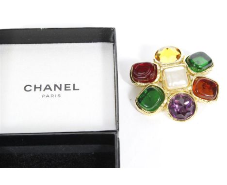 Chanel: A '26' series costume brooch, the central square form faux pearl within a border of multi coloured 'stones', all set 