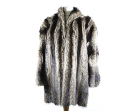 An early 1980's racoon fur jacket, long length, having small self lined collar, hook fastening to front, slit pockets and wid