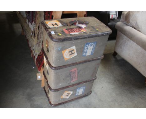 A wooden bound canvas travelling trunk bearing some labels