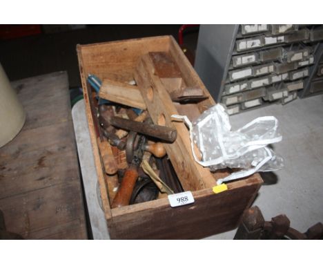 A wooden box and contents of various hand tools