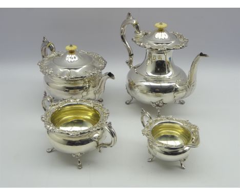 Edwardian four piece silver tea and coffee set of circular design with a floral chased border pattern, the teapot and coffee 