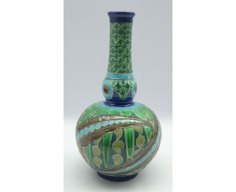 Burmantofts faience ware flask shape vase, incised decoration in shades of blue, green etc with impressed marks to base H37cm