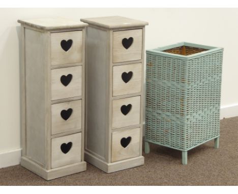 Two narrow four drawer chests with pierced heart handles (W25cm, H80cm, D28cm), and a Lloyd Loom style wicker linen bin Condi