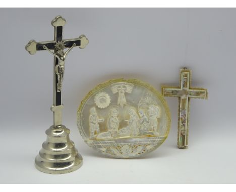 Mother of pearl shell, carved with a religious scene on an easel stand W 18cm, a Jerusalem shell mounted cross and a metal ta