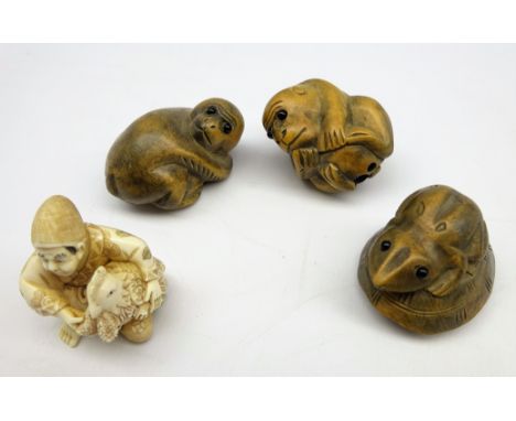 Ivory netsuke carved as a figure holding a chicken, a wooden netsuke in the form of a frog and two others (4) Condition Repor