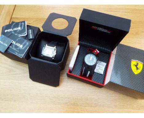 Two designer watches - Ferrari Pit Crew black watch with white batons in presentation case with manual, and a Police Cobra wa