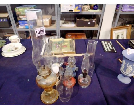 Six glass and ceramic paraffin lamps and a silver plated candle holder with chimney. Not available for in-house P&amp;P 