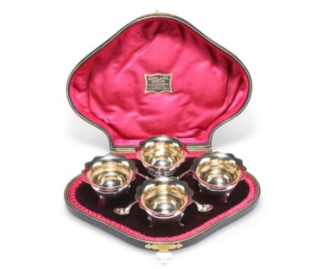 A SET OF FOUR EDWARDIAN SILVER SALTS,&nbsp;by William Aitken, Birmingham 1902, circular with shaped rim, raised on three shel