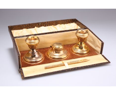 A PAIR OF GEORGE V SILVER-GILT CANDLESTICKS AND INKWELL,&nbsp;by&nbsp;Marson &amp; Jones, Birmingham 1929, cased, each with b