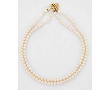 A 9 CARAT GOLD CULTURED PEARL NECKLACE, two strands of uniform cultured pearls strung to a 9 carat gold knot motif clasp, hal