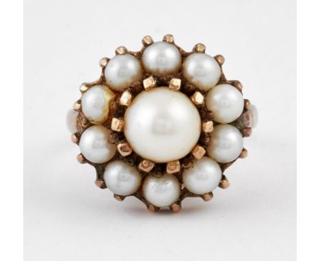 A CULTURED PEARL CLUSTER RING, a central cultured pearl within a border of smaller pearls, partially hallmarked London 1970, 