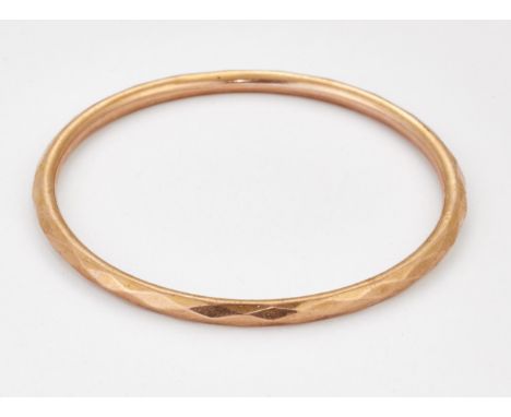 A 9 CARAT ROSE GOLD BANGLE, of faceted design, hallmarked Chester 1923. 7.8cm inner diameter, 8.6 gramsCONDITION REPORTLight 