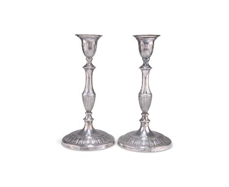 A PAIR OF GEORGE V SILVER CANDLESTICKS,&nbsp;by Goldsmiths &amp; Silversmiths Co Ltd, London 1916, the circular base with ree