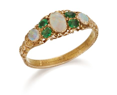 AN EMERALD AND OPAL RING, oval and round opals spaced by oval-cut emeralds in carved settings, to a foliate engraved shank, r