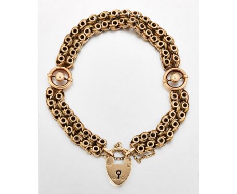 A FANCY LINK BRACELET, two rows of scrolling links spaced by beaded circular links, to a 9 carat gold padlock clasp, clasp ha