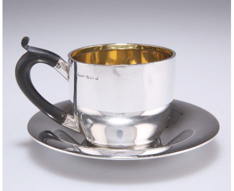 AN EDWARDIAN SILVER CUP AND SAUCER,&nbsp;by T H Hazlewood &amp; Co,&nbsp;Birmingham 1908, plain, the cup with gilded interior