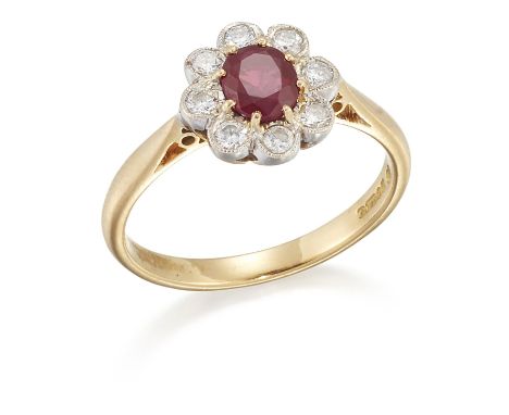 AN 18 CARAT GOLD RUBY AND DIAMOND CLUSTER RING, an oval-cut ruby within a border of milgrain-set round brilliant-cut diamonds