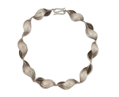GERLINDE HUTH - A SHELL NECKLACE, formed of brush-polished abstract shell links, to hook fittings, maker's mark 'GH'. Length 