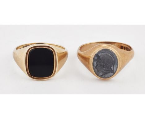 A 9 CARAT GOLD HEMATITE&nbsp;INTAGLIO SIGNET RING, hallmarked London 1976, ring size S1/2; and A 9 CARAT GOLD ONYX SIGNET RIN