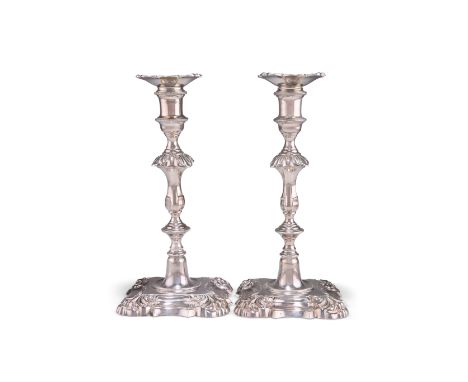 A PAIR OF ELIZABETH II SILVER CANDLESTICKS,&nbsp;by Nayler Brothers, London 1968, cast in George II style, the shaped stepped