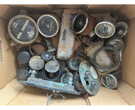 A box of assorted vintage car gauges. 