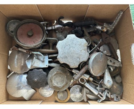 A box of vintage car spares to include fuel caps, bonnet catches, door handles etc. 