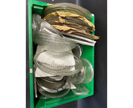 A box of pre-war new old stock glass lamp covers inc. Lucas King of the Road etc. 