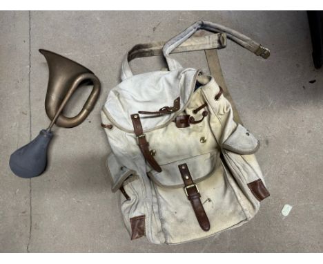 A Bugatti-style haversack (used in the 2023 Nuvolari road rally) and a brass car horn. 
