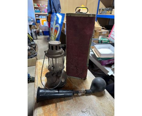 An Edwardian copper footwarmer, a hurricane lamp and an early car horn. 