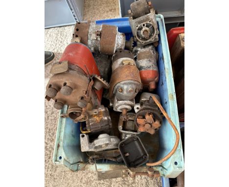 A box of various vintage magnetos. 