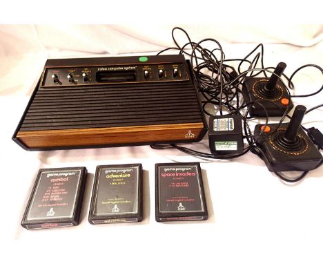 Atari video computer system CX-2600 console, with combat game program cassette, space invaders and adventure two joystick con
