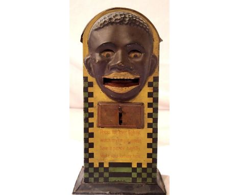 Tinplate black Americana money box, by D.R.G.M. German, press the lever and tongue comes out advertising Lyons Tea and the ey