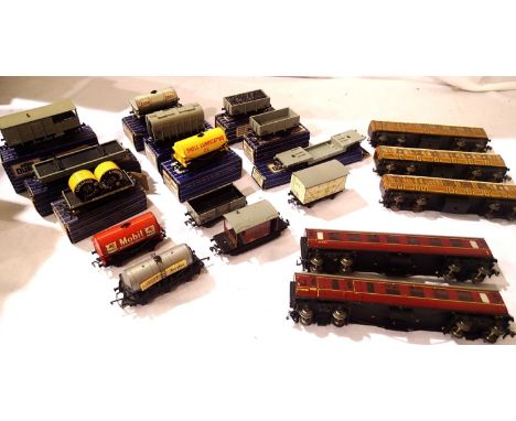 Thirteen Hornby Dublo wagons, Wrenn six wheel tanker, three teak coaches, two BR Maroon coaches, mostly three rail, some two 