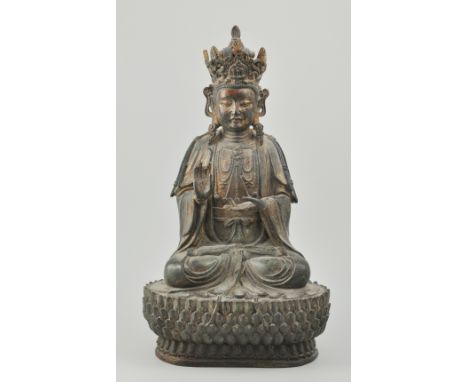 Chinese bronze figure of a Buddha, probably Ming Dynasty, cross legged figure with scroll crown, flowing robes and raised rig