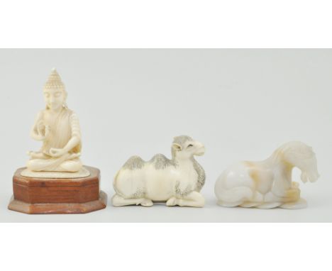 Carved ivory model of a seated camel, a jade model of a recumbent horse and a carved ivory Buddha (3).