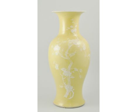 Chinese yellow baluster shaped vase, prunus pattern, four character mark, painted in white enamel with birds amongst flowerin