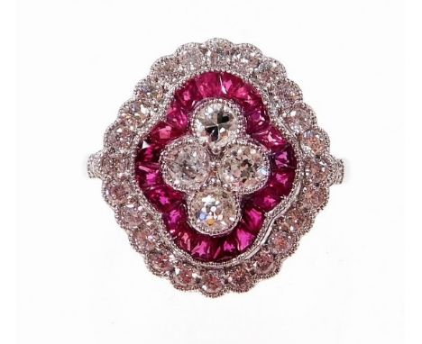 A Victorian style ruby and diamond cluster ring, with four central round brilliant cut diamonds, with outer halo of baguette 