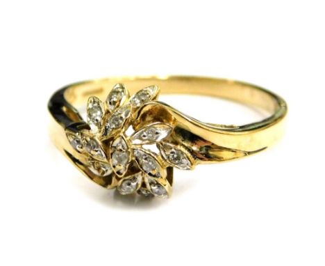 A 9ct gold dress ring, floral design with twist shoulders, set with tiny white stones, makers stamp QVC, ring size O, 2.2g al