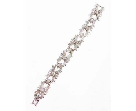 A diamond set vintage cocktail bracelet, with bow type link design, each centred by an old cut diamond, and various other rou