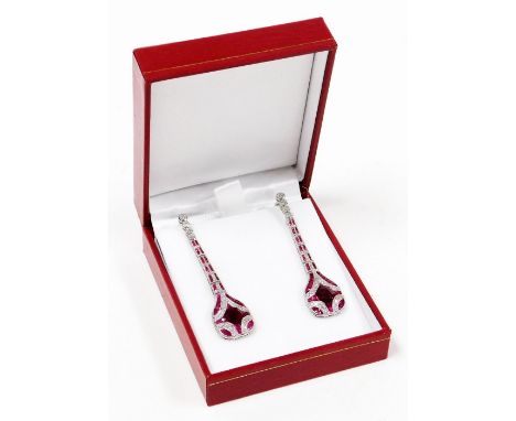 A pair of Art Deco style ruby and diamond drop earrings, the design with various baguette and round cut stones, the rubies to