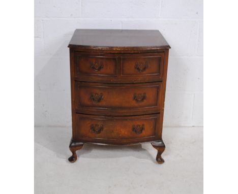 A mid century mahogany bow-fronted bedside chest of three drawers, with carved detailing, raised on cabriole legs - length 48