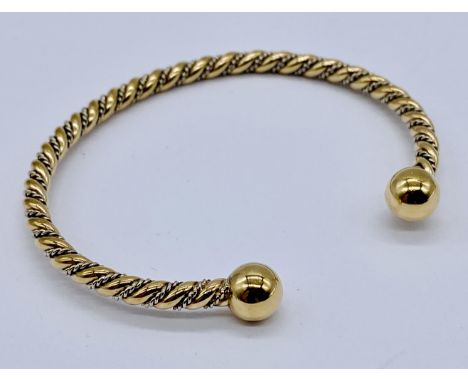 A 9ct two colour gold "torque" bangle weight 14.3g